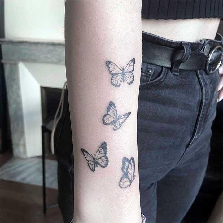 butterfly tattoo on wrist with name