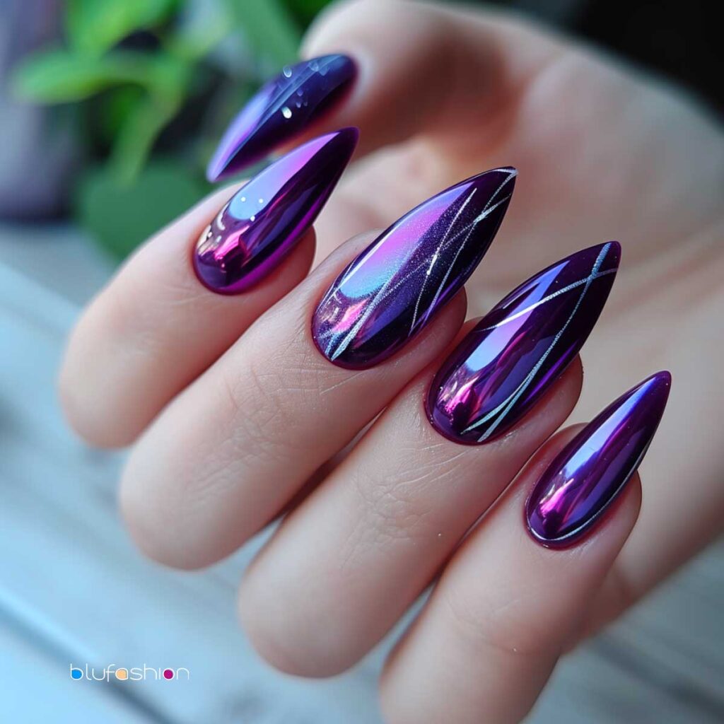 Hand showcasing stiletto nails with a reflective purple chrome and geometric design.