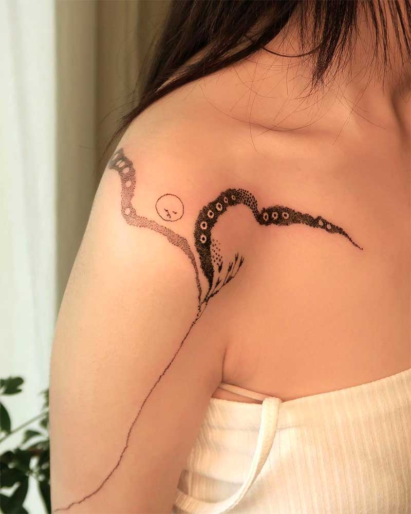 A young women with a snake Shoulder Tattoos