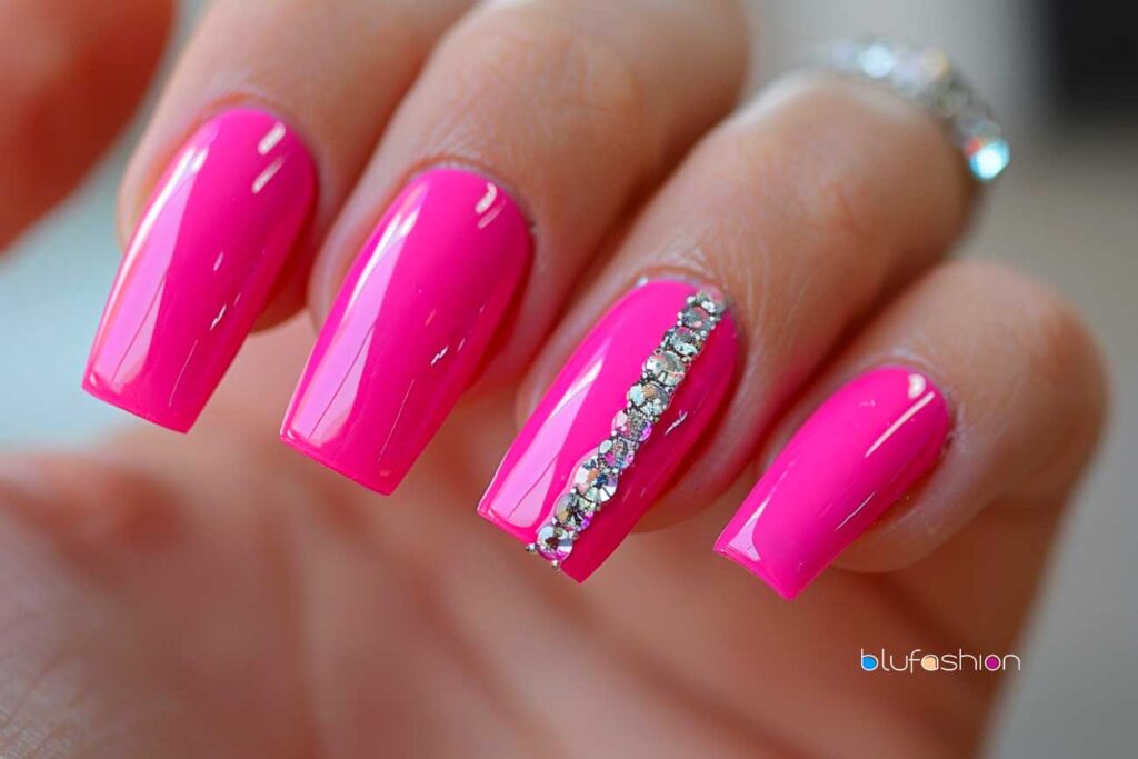 Elegant hot pink square-shaped nails with a single accent nail featuring a straight line of sparkling diamonds, combining bold color with a touch of glamour.