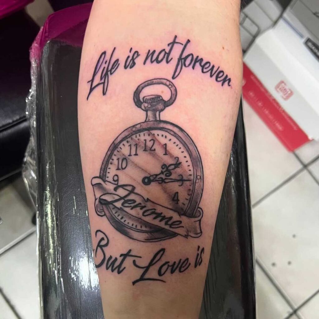 Black ink pocket watch tattoo with inspirational quote 'Life is not forever but Love is' on forearm.