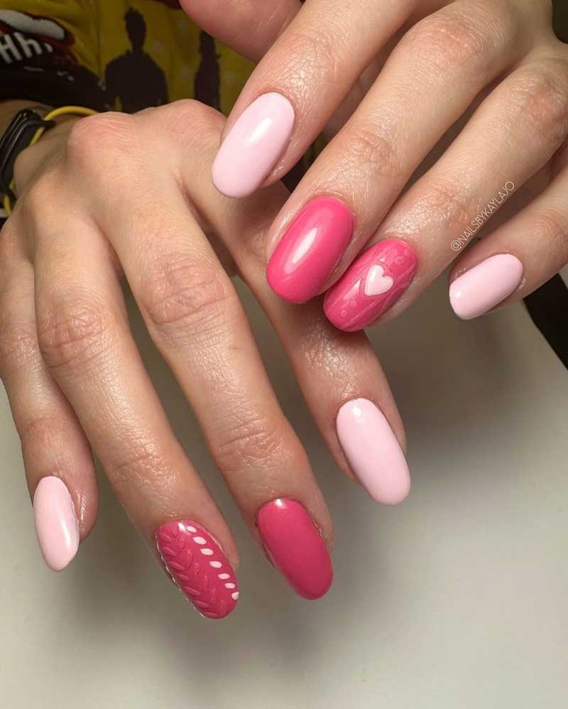 Variety of pink oval nails with glossy finish and white heart accent for a romantic look.