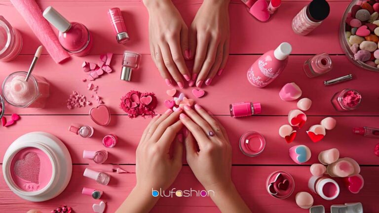 Assortment of pink nail polishes and heart decorations on a table for manicure art.