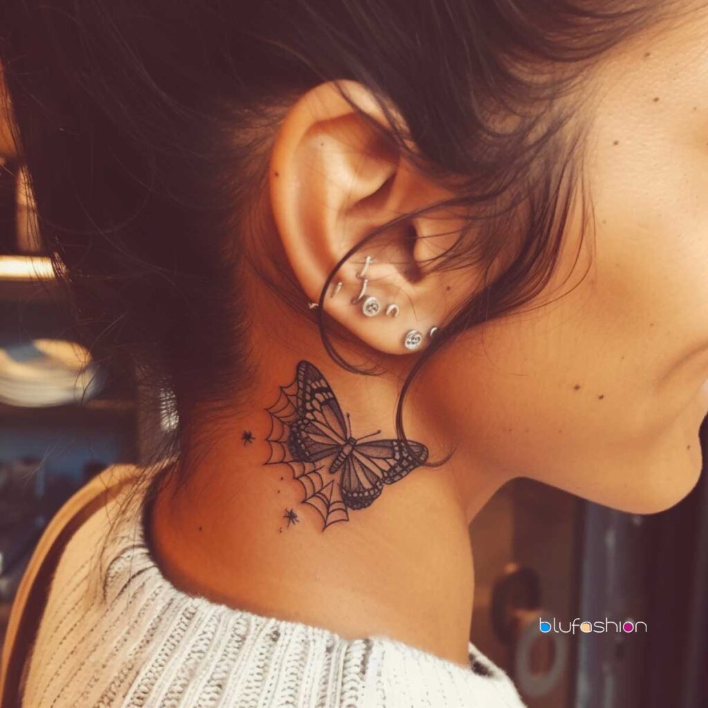 Detailed butterfly with web neck tattoo on woman with multiple ear piercings.