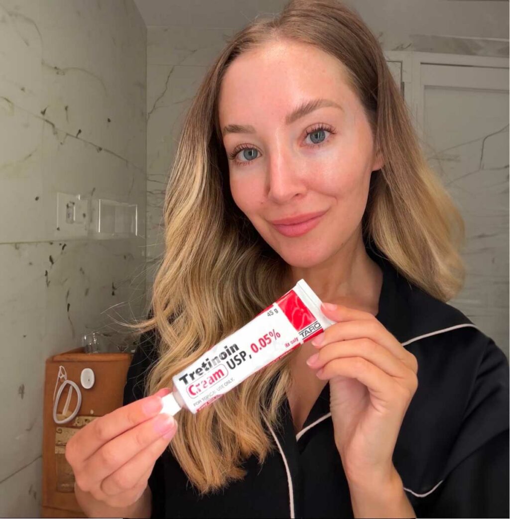 A woman holding tretinoin cream.