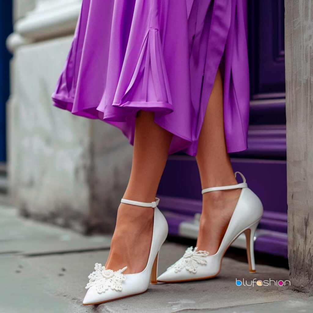 Chic white ankle-strap heels with elegant lace detailing, perfectly complementing a vibrant purple flared dress.