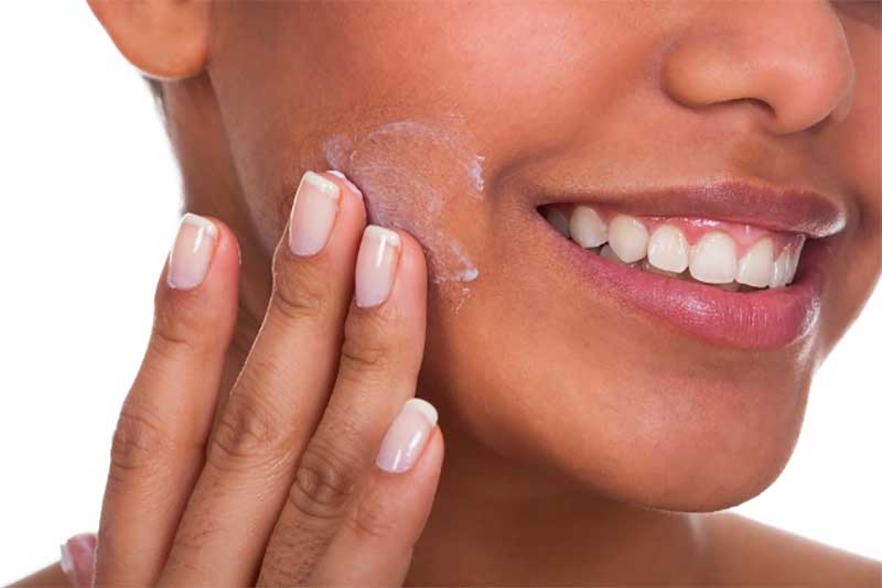 Woman Applying Face Cream