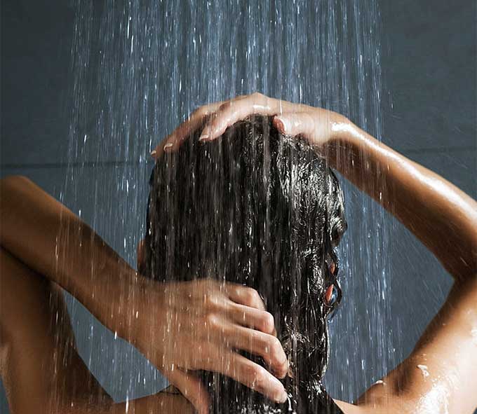 Woman washing her hair in shower